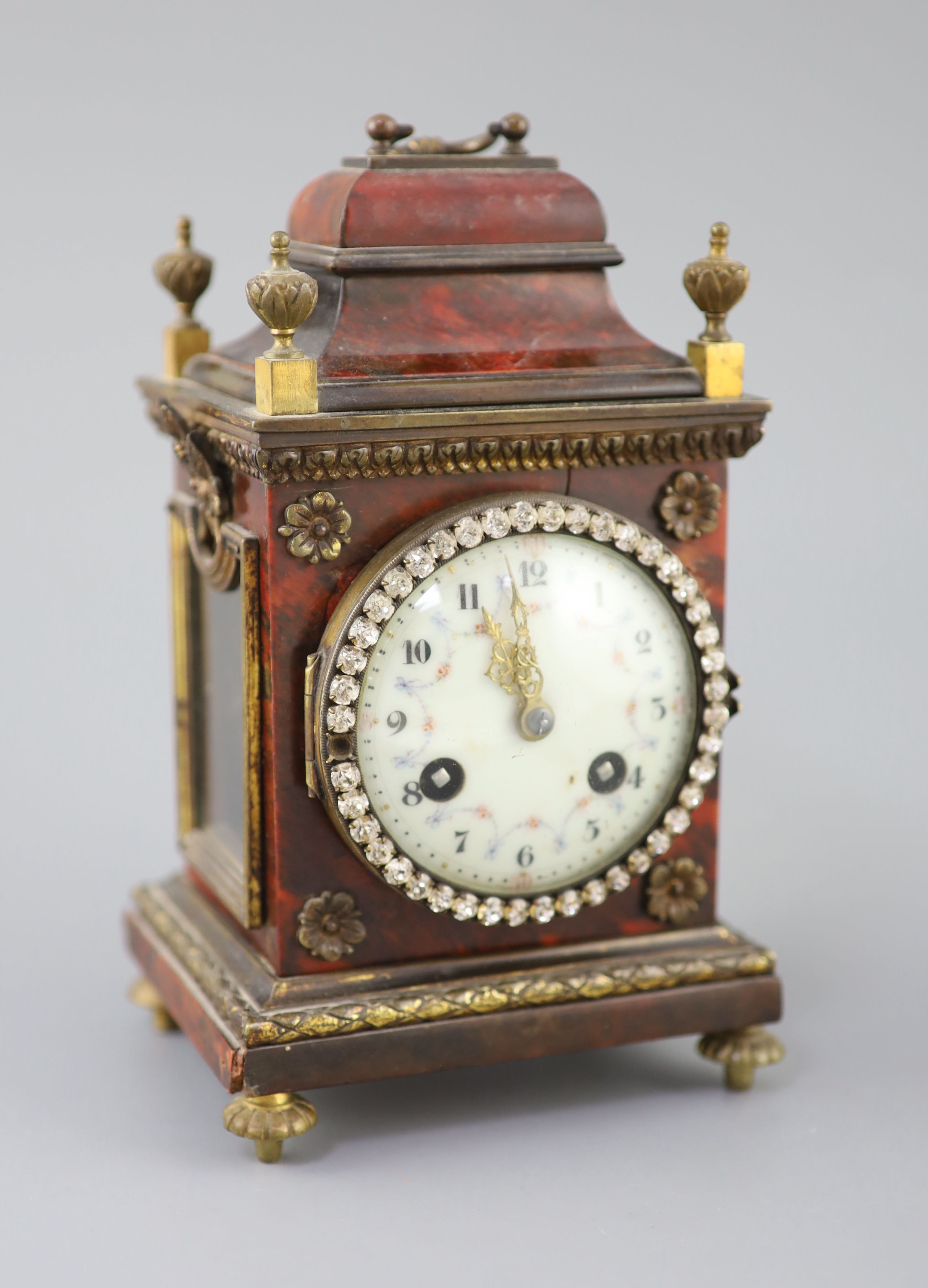 An early 20th century red tortoiseshell veneered mantel timepiece, height 8in.